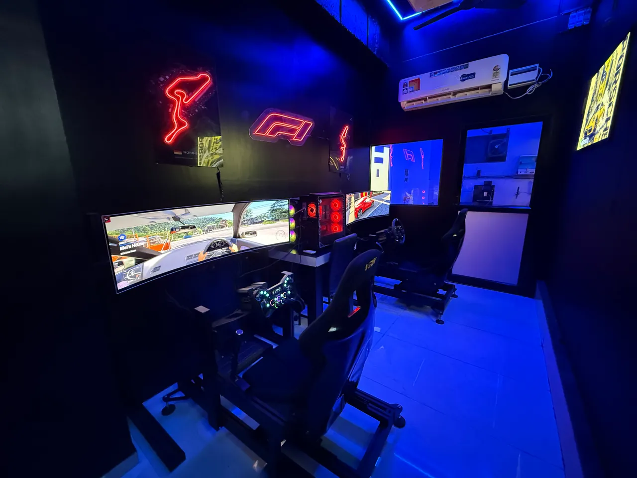 The two sim racing cockpits and their curved screens in the Sim Racing room at Intencity Undri