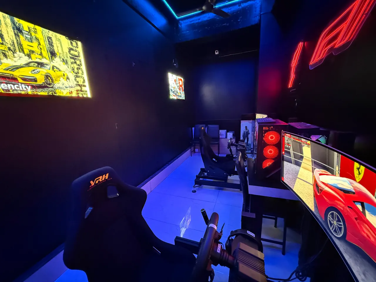 Racing seat and wheel beside the curved screen in the Sim Racing room at Intencity Undri