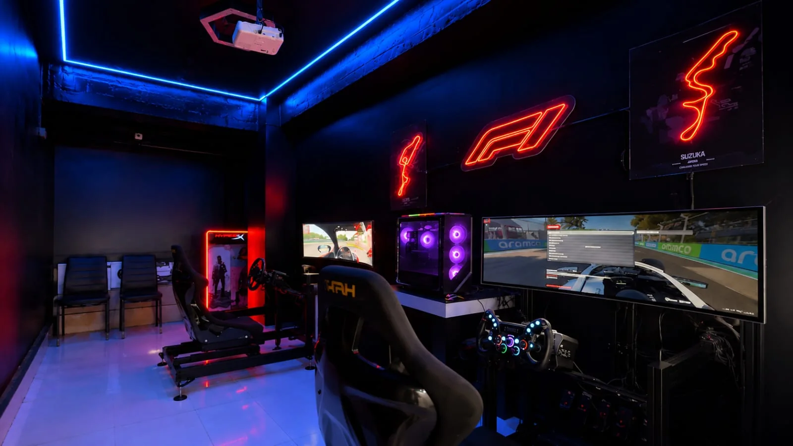 The Sim Racing room at Intencity Undri: two Moza cockpits with curved ultrawide screens under red neon track signs